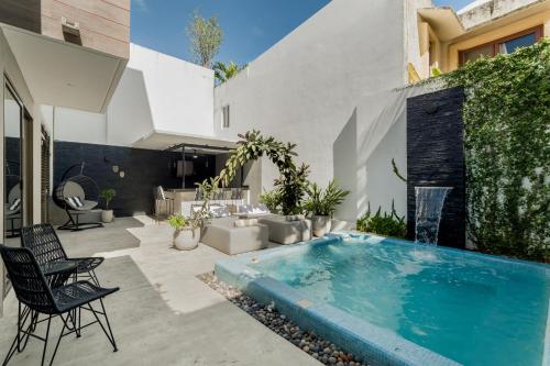 a swimming pool in the backyard of a house at CASA LIMA- Executive Design Suites in Cancún