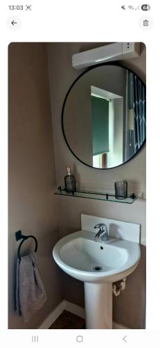 a bathroom with a white sink and a mirror at Orkney,Shapinsay in Kirkwall