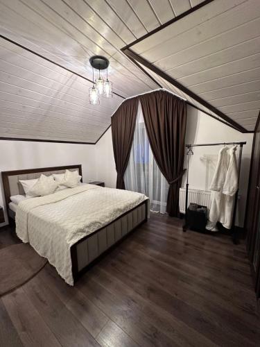 a bedroom with a bed and a chandelier at Brick House in Slavske