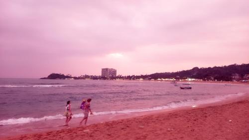 two people walking on the beach at skymirror unawatuna in Unawatuna