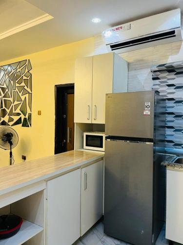 a kitchen with a stainless steel refrigerator and a counter at OS Dominion Homes in Mama