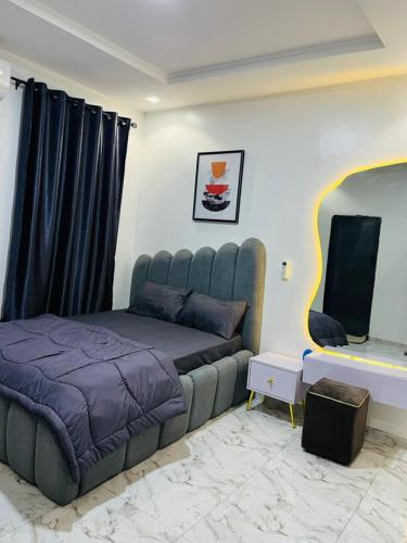 a bedroom with a bed and a flat screen tv at OS Dominion Homes in Mama