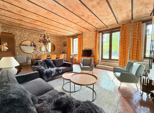 a living room with couches and chairs and a table at La Fauconnerie Du Roy in Montainville