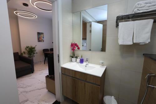 a bathroom with a sink and a mirror at 1 Bed Junior near Cleveland and Galleria Mall by Central Stay in Abu Dhabi