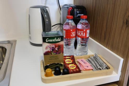 a tray with two bottles of water and other items at 1 Bed Junior near Cleveland and Galleria Mall by Central Stay in Abu Dhabi