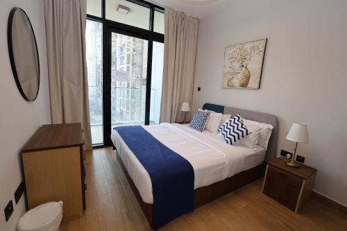 a bedroom with a large bed and a large window at 1 Bed Junior near Cleveland and Galleria Mall by Central Stay in Abu Dhabi