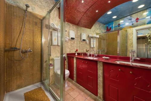 a bathroom with a shower and a sink and a toilet at boutique hotel FASHI NIK in Rhodes Town