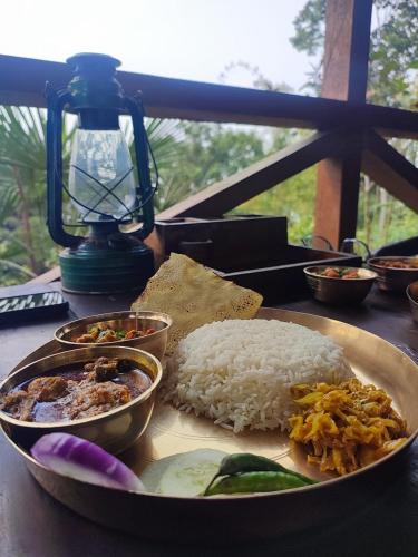 a plate of rice and other food on a table at MountainBrew Homestay in Takdāh