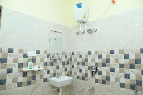 a bathroom with a sink and a mirror at serene cottage in Yelagiri