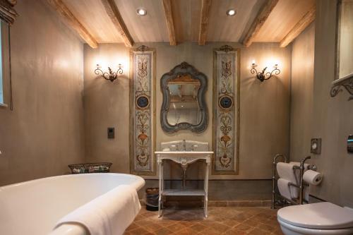 a bathroom with a tub and a sink and a toilet at Crab Manor Hotel in Thirsk