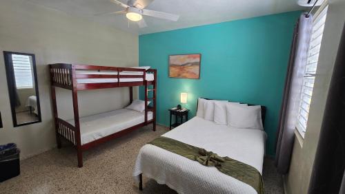 a bedroom with a bed and a bunk bed at I Love Combate Rooms & Suites in Boqueron