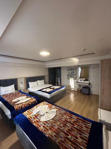 a hotel room with two beds and a living area at Divas Silver in Istanbul