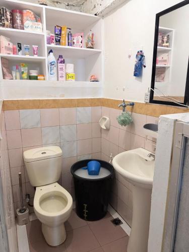 a bathroom with a toilet and a sink at Manzanares Homestay in San Jose