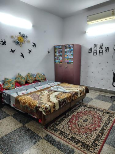 a bedroom with a bed in a room with a rug at The Rest Nest in Gorakhpur