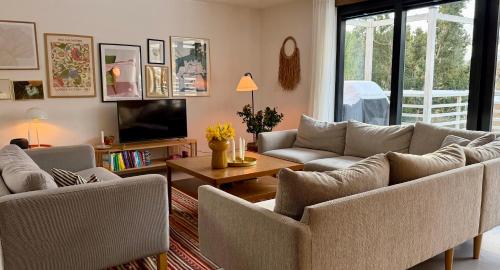 a living room with two couches and a tv at Cheerful house, close to lakes in Farum