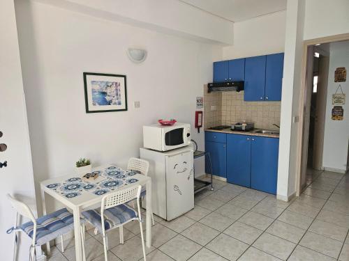 a small kitchen with a table and a microwave at C & A Hotel Apartments in Polis Chrysochous