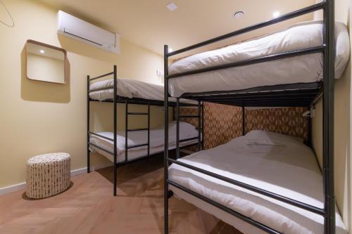 a room with three bunk beds in a room at Gelk in Groningen