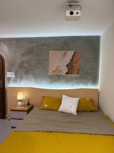 a bedroom with a bed with two pillows at Dana Home MT in Danang