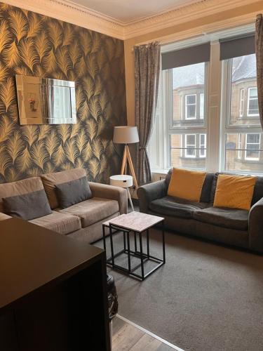 a living room with a couch and a table at Stunning apartment on Perth Rd-mins from City Centre Dundee in Dundee