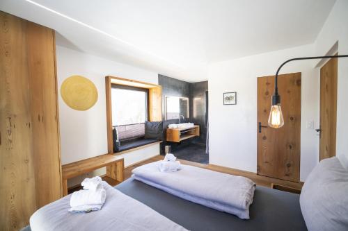 a room with two beds and a mirror at Chasa Vital in Sent