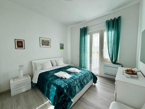 a white bedroom with a bed and a window at Chianti 22 in Poggibonsi