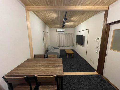 a room with a table and a couch and a television at Guest house TOMORI - Vacation STAY 11064v in Shingū