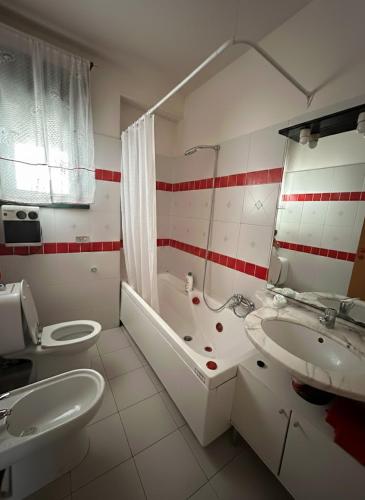 a bathroom with a sink and a toilet and a tub at Taormina Sky View in Taormina