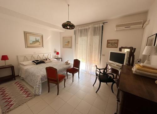 a bedroom with a bed and a desk and a television at Taormina Sky View in Taormina