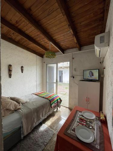 a bedroom with a bed and a table in it at Inactivo in Chuy