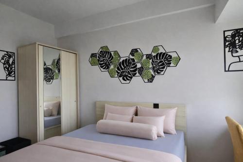 a bedroom with a bed and a mirror at Soft Reset Room by YOMAIN in Kemirimuka Tiga