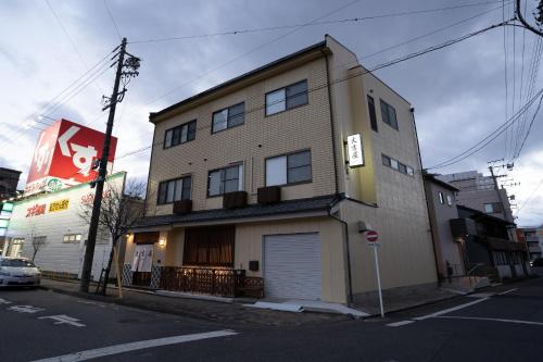 a building on the corner of a street at 大吉屋本館 ワンフロア貸切部屋 名駅離れ in Nagoya