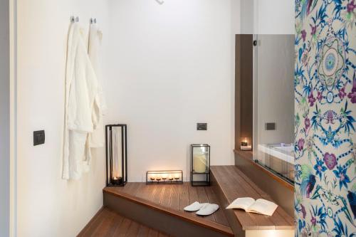 a bathroom with a wooden counter with a mirror at Palazzo Sovrana Serviced Luxury Apartments in Palermo