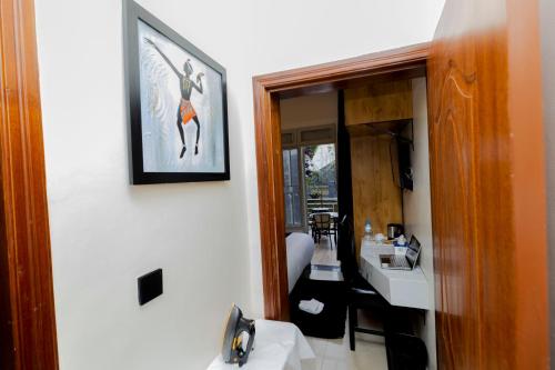 a bathroom with a sink and a mirror at One Click Cozy Suites in Kigali