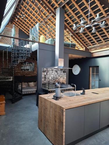 a kitchen with a wooden counter and a sink at L'entrepôt Spadois in Spa