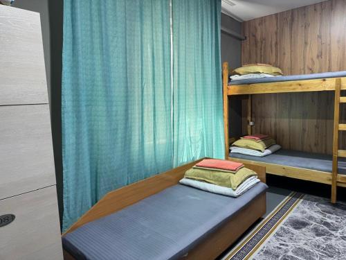 two bunk beds in a room with a curtain at DelLuna in Almaty