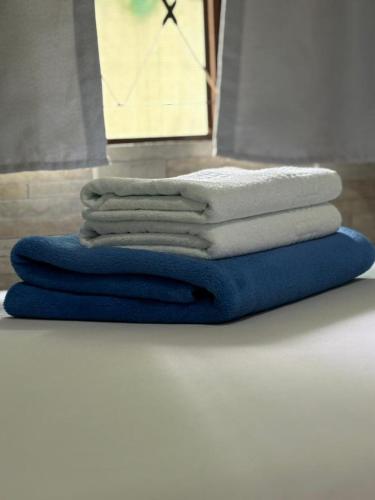 a stack of towels sitting on top of a table at Pouso do Carmo in Pirenópolis