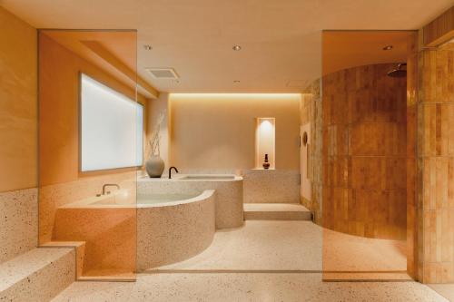 a large bathroom with a tub and a shower at etoe Hotel Shinjuku in Tokyo