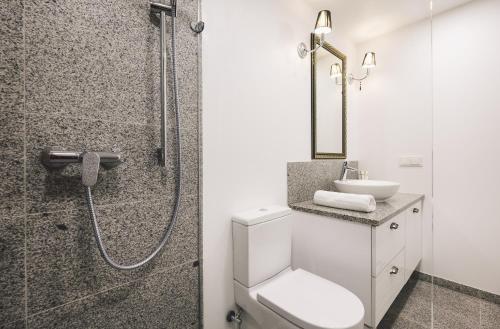 a bathroom with a shower and a toilet and a sink at Jacuzzi Romantic Apartment in Klaipėda