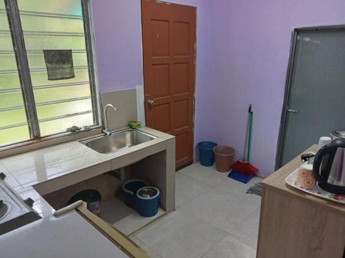 a kitchen under construction with a sink and a door at Hanny Cozy Homestay in Kuala Lipis