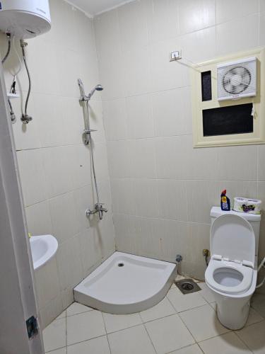 a bathroom with a toilet and a sink at Ground floor Garden & Pool & Beach Studio in Sharm El Sheikh