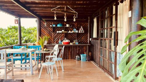 an outdoor patio with a table and chairs at Nhà Bên Hồ in Bảo Lộc