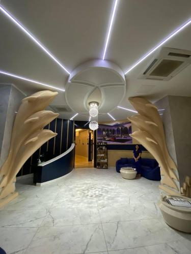 a lobby with a large room with a ceiling with wings at Serenity Residence in Alanya