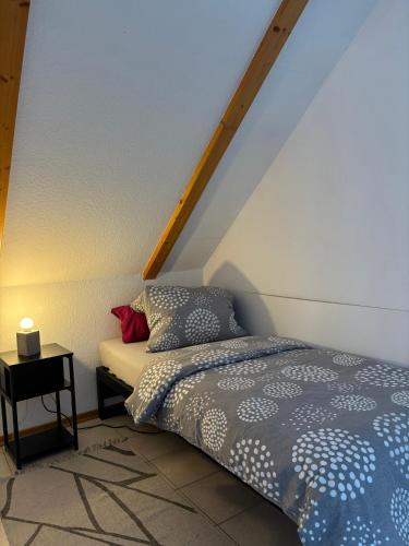 a bedroom with a bed and a side table at FEWO Eggenstein beim KIT in Eggenstein-Leopoldshafen
