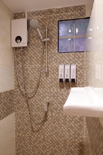 a bathroom with a shower and a white sink at The Krabi Forest Homestay in Ao Nang Beach