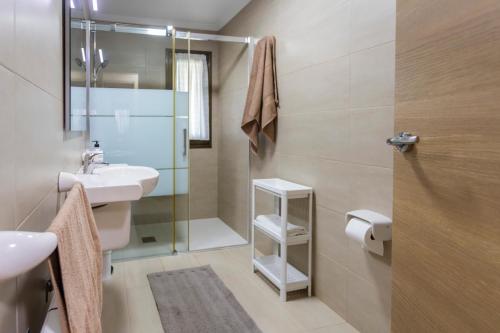 a bathroom with a sink and a shower at Apartamentos Carolina in Celorio