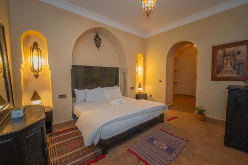 a bedroom with a large bed in a room at Mumtaz Dar in Marrakesh