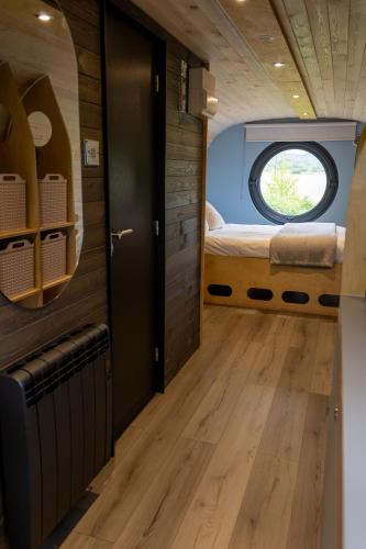 a small room with a bed and a window at Highland Gateway Glamping in Clackmannan