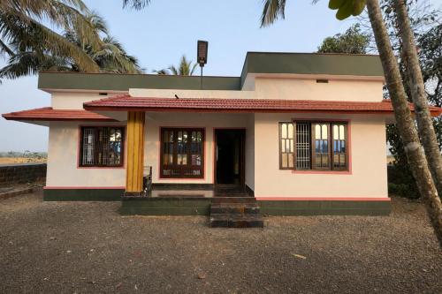 a small house with a porch at Golden Breeze Bekal in Bedadka