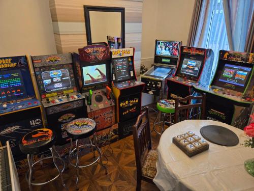 a room filled with lots of video game machines at Titanic Sailortown Belfast City Centre townhouse in Belfast