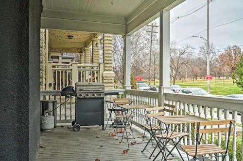 a porch with a grill and tables and chairs at Jungle House Columbus Downtown Free Parking Sleeps 6 - Steps to Convention Center & Nationwide Arena - 1BR Short North Luxury Home - Over 5,800 Five Star Stays in Columbus